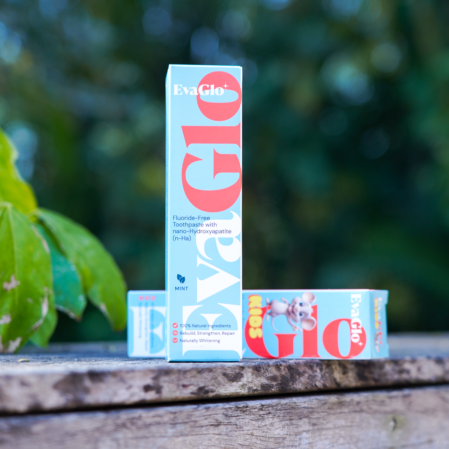 ExaGlo toothpaste packaging on a wooden surface with a blurred green background